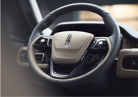 The intuitively placed controls of the steering wheel on a 2023 Lincoln Aviator® SUV
