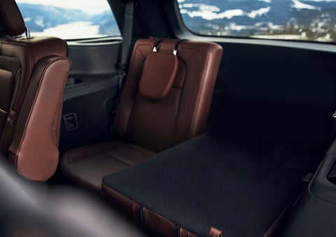 The left rear seat of a 2024 Lincoln Aviator® SUV is shown folded flat for additional cargo space | Stivers Lincoln in Waukee IA