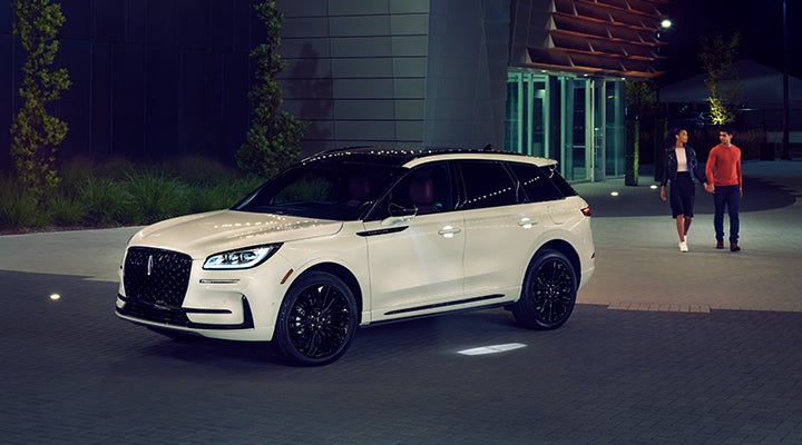 Two people approach a 2024 Lincoln Corsair® SUV featuring the available Jet Appearance Package. | Stivers Lincoln in Waukee IA