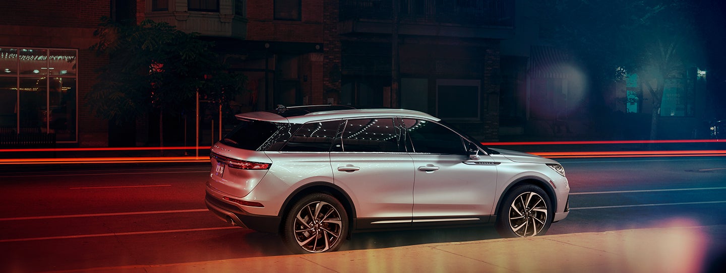 The 2024 Lincoln Corsair® SUV is parked on a city street at night. | Stivers Lincoln in Waukee IA
