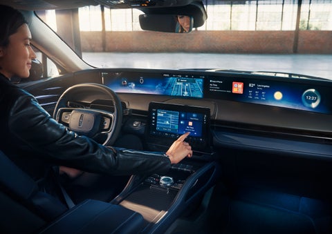 The driver of a 2024 Lincoln Nautilus® SUV interacts with the center touchscreen. | Stivers Lincoln in Waukee IA