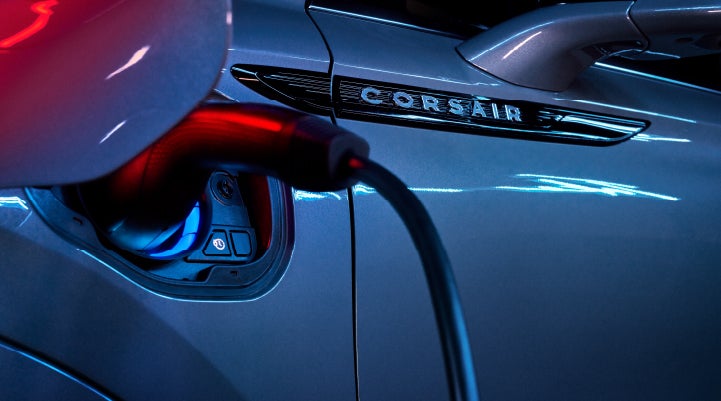 A charger plugged into the charging port of a 2024 Lincoln Corsair® Plug-in Hybrid model. | Stivers Lincoln in Waukee IA