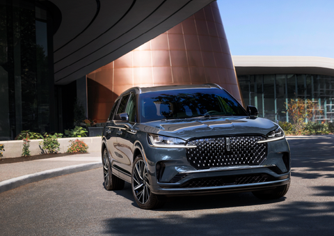 A gray 2025 Lincoln Aviator® SUV is parked outside a modern building with the sun shining. | Stivers Lincoln in Waukee IA