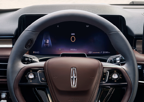 The steering wheel of 2025 Lincoln Aviator® SUV is shown with black and brown accents. | Stivers Lincoln in Waukee IA