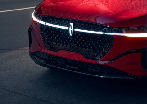 The available front LED light bar and center Lincoln Star logo glow at dusk. | Stivers Lincoln in Waukee IA