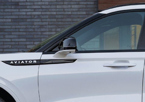 The driver’s side door and fender badging of a white 2026 Lincoln Aviator® SUV are showcased. | Stivers Lincoln in Waukee IA