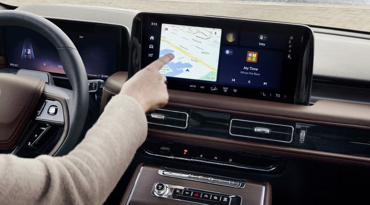 A person is tapping the center display touchscreen of a 2026 Lincoln Aviator® SUV. | Stivers Lincoln in Waukee IA