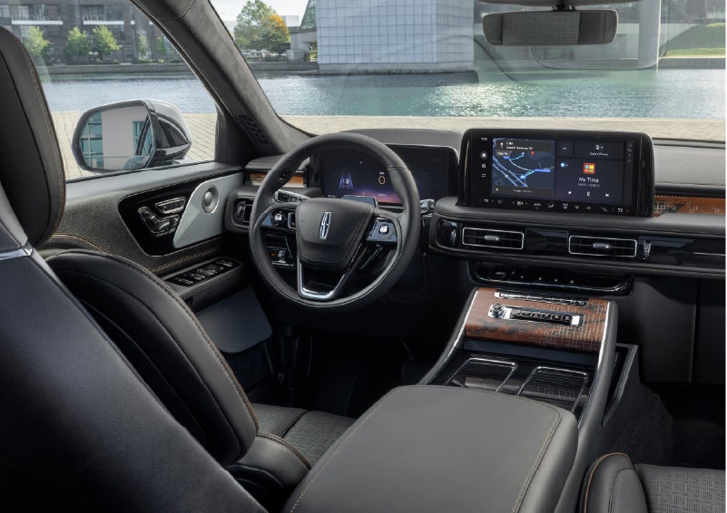 The interior of the 2026 Lincoln Aviator® SUV is shown parked with a view of a harbor through the windshield. | Stivers Lincoln in Waukee IA