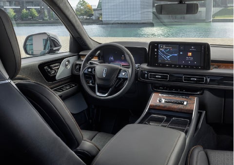 The interior of the 2026 Lincoln Aviator® SUV is shown parked with a view of a harbor through the windshield. | Stivers Lincoln in Waukee IA