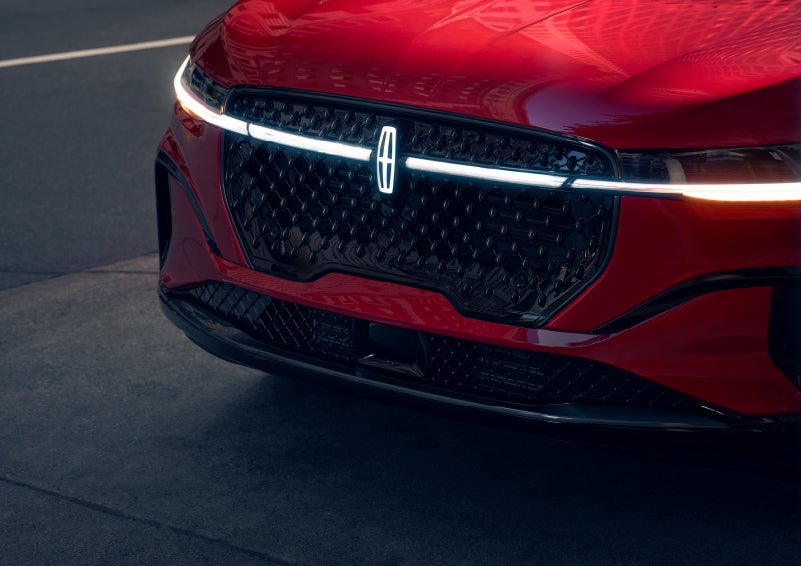 The available front LED light bar and center Lincoln Star logo glow at dusk. | Stivers Lincoln in Waukee IA