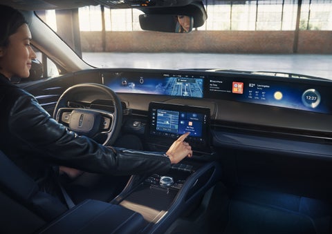 The driver of a 2026 Lincoln Nautilus® SUV interacts with the center touchscreen. | Stivers Lincoln in Waukee IA