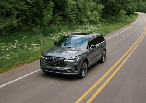 A 2027 Lincoln Aviator® SUV is being driven down a road. | Stivers Lincoln in Waukee IA