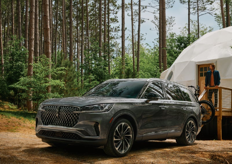 A 2027 Lincoln Aviator® is parked next to a high end glamping site. | Stivers Lincoln in Waukee IA