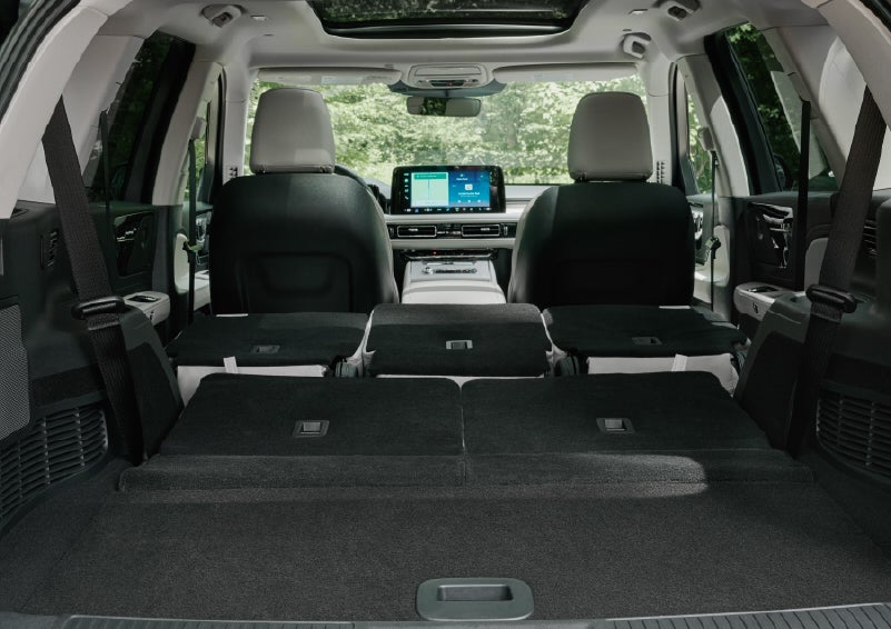 A rear to front view of the interior of a 2027 Lincoln Aviator® Black Label™ SUV shows the third and second rows folded flat | Stivers Lincoln in Waukee IA
