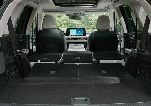 A rear to front view of the interior of a 2027 Lincoln Aviator® Black Label™ SUV shows the third and second rows folded flat | Stivers Lincoln in Waukee IA