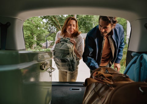 A couple loads luggage into the rear of a 2027 Lincoln Aviator® Black Label™ SUV..e 202 | Stivers Lincoln in Waukee IA