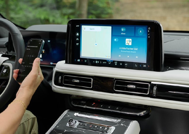 A person pairs thier phone with the center touchscreen of a 2027 Lincoln Aviator® Black Label™ SUV | Stivers Lincoln in Waukee IA